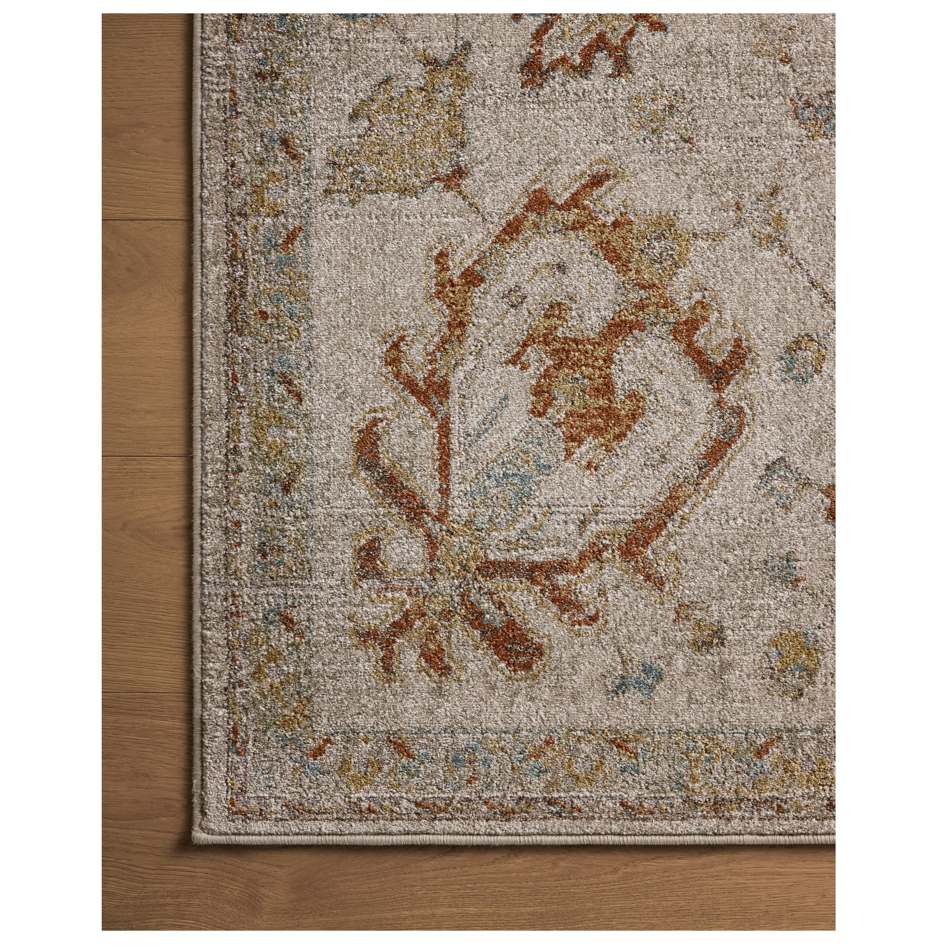 Mona Oatmeal Multi Rug close up of corner on wood floor