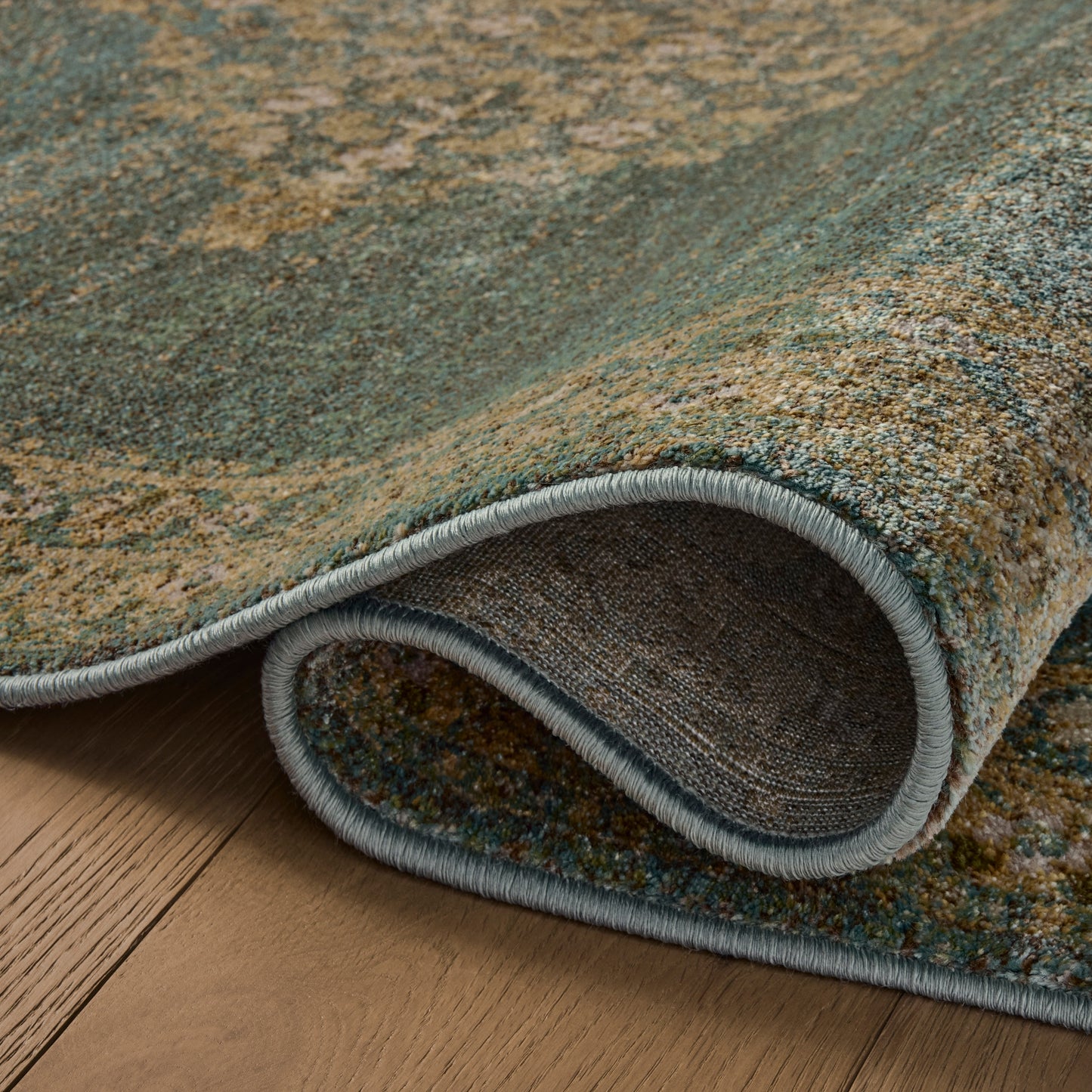 Mona Aqua Wheat Rug close up of rolled rug
