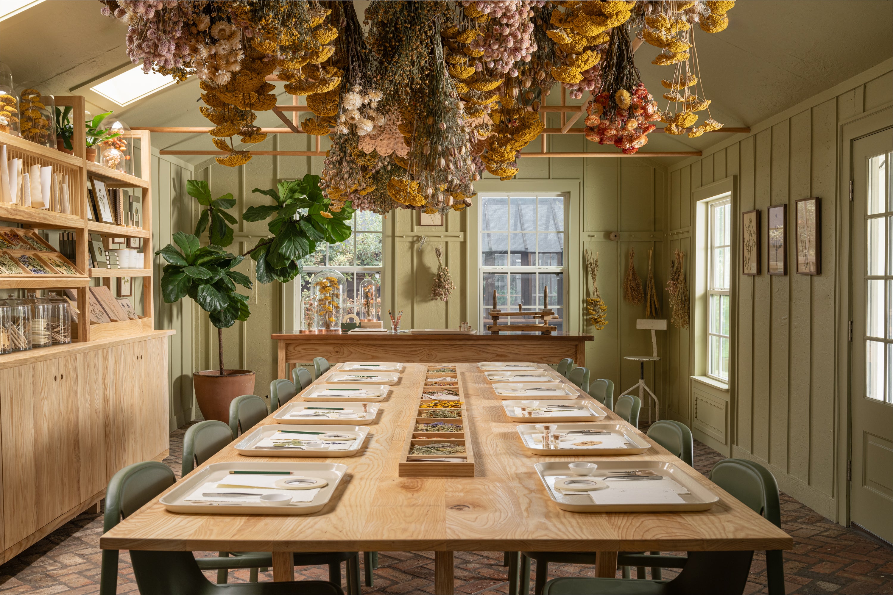 The Herbarium at the Silos with a long wooden table set for crafting