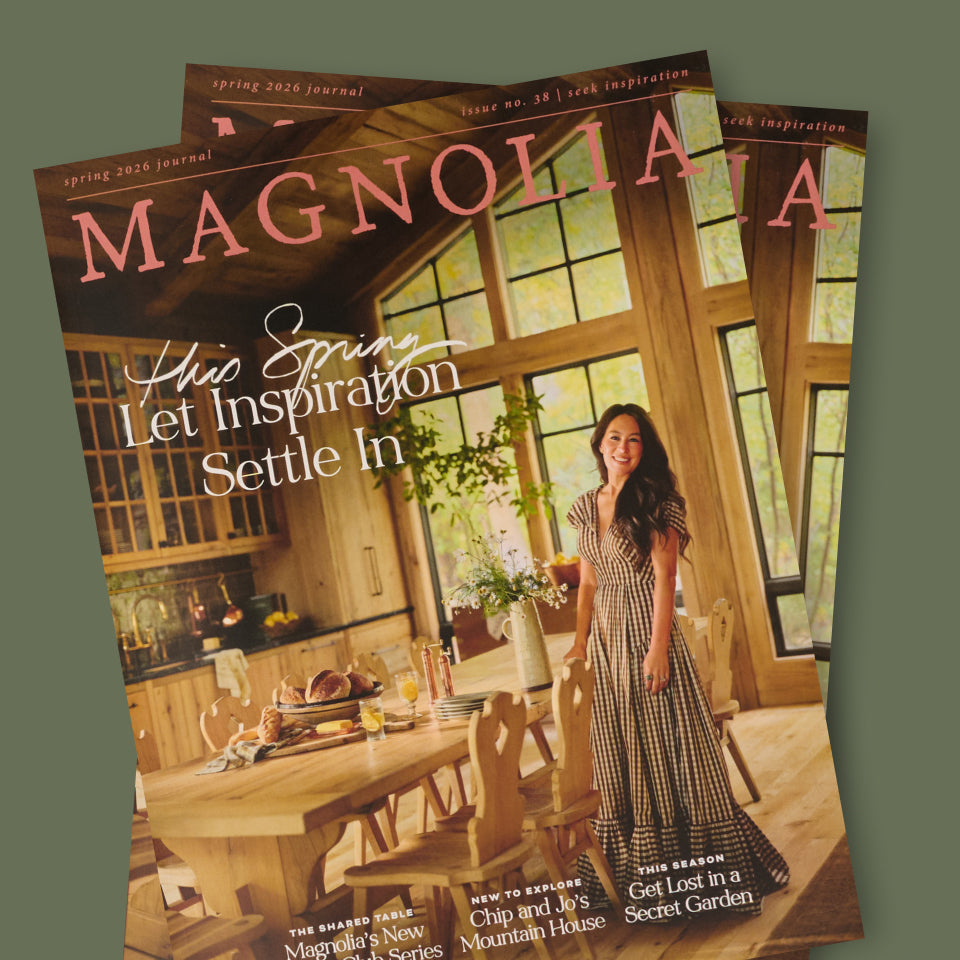 Two copies of 'Magnolia Journal' magazine with Joanna Gaines in a checkered dress standing in a kitchen.