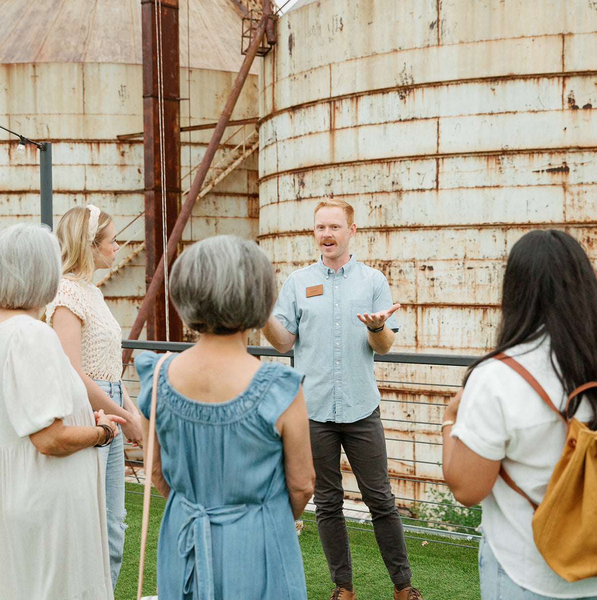 Group of people listening to a guide in front of the Silos