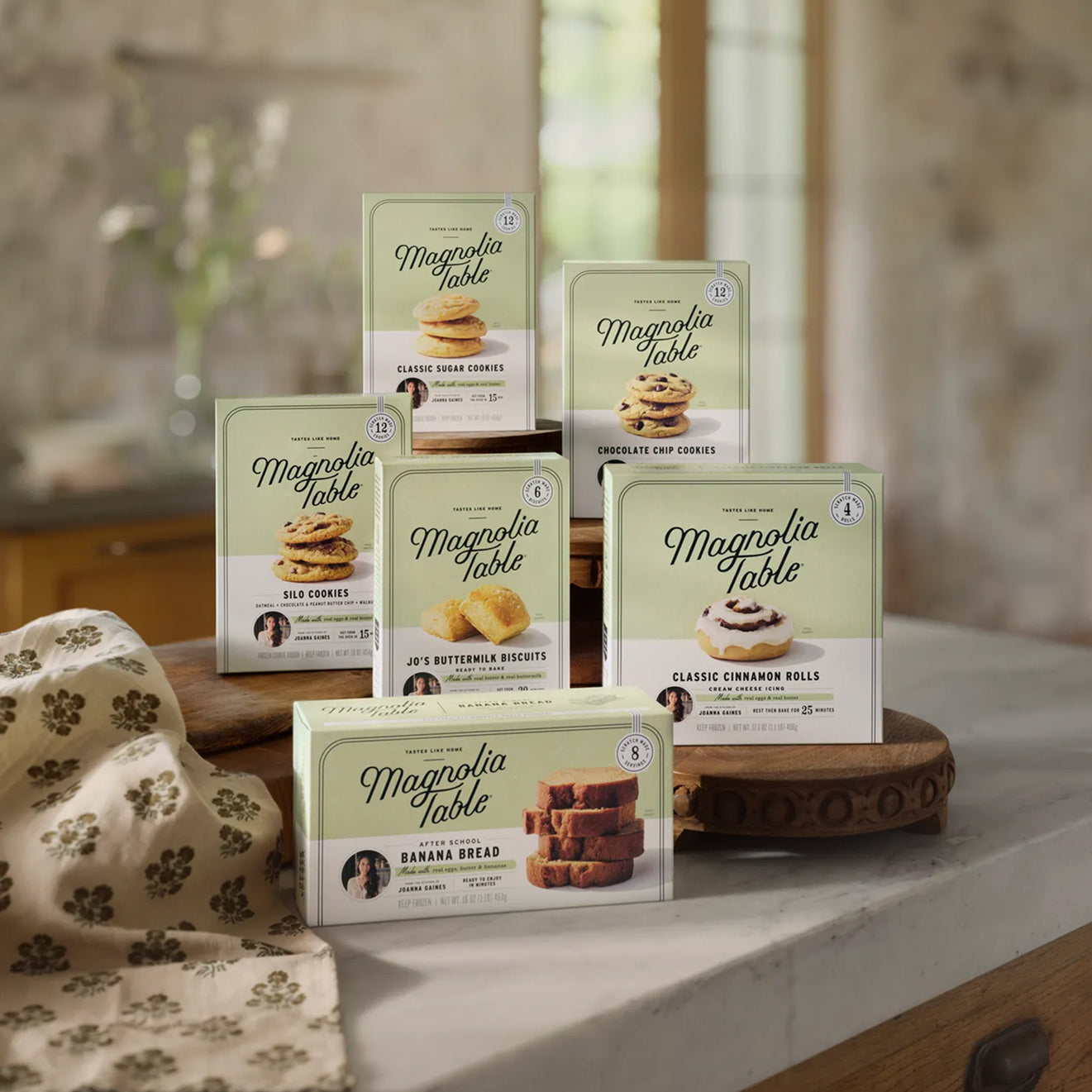 Collection of all six Magnolia Table Frozen Food product packages on a kitchen counter.