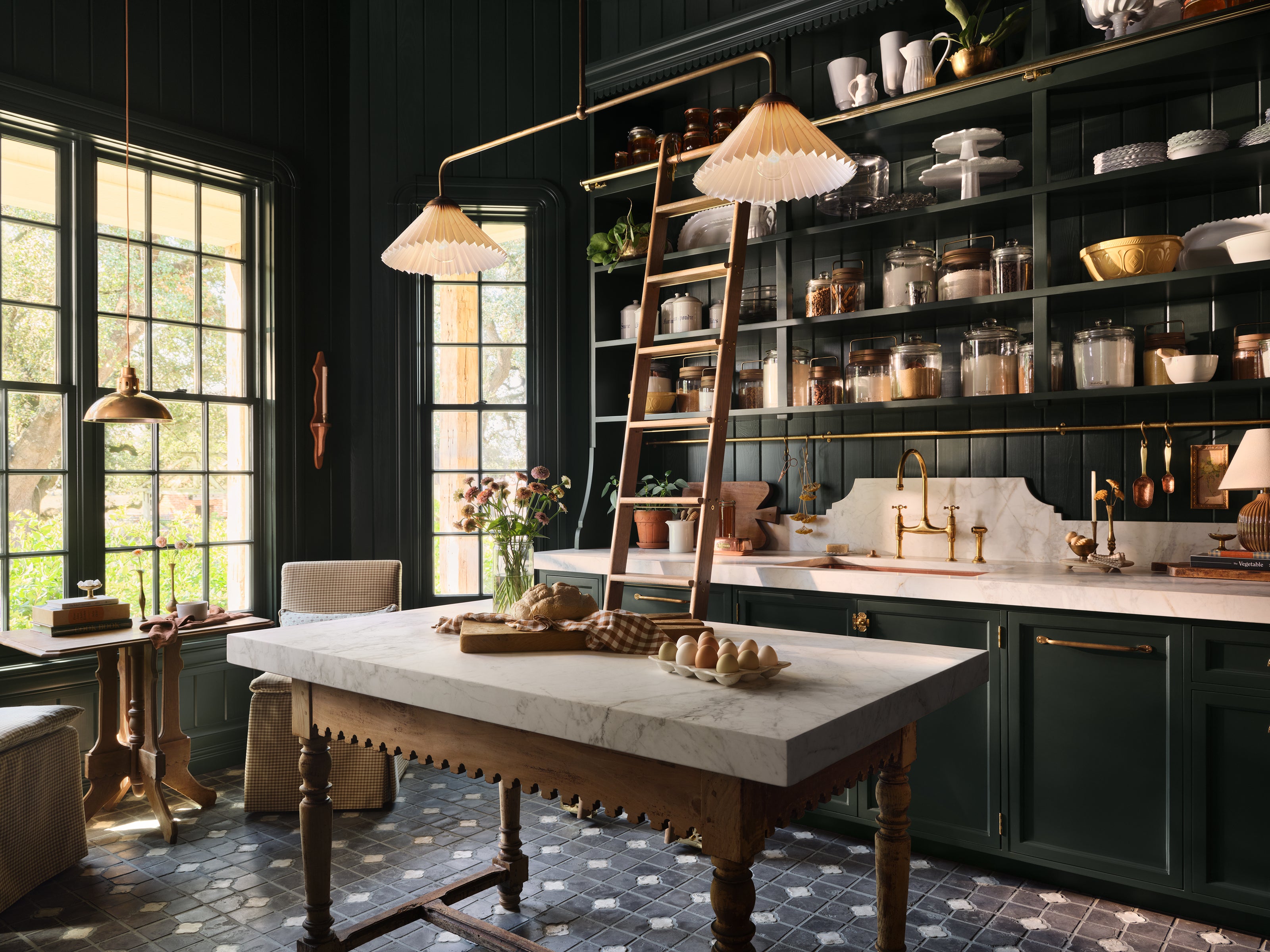 Butler's pantry with dark wood cabinets, marble countertops, and a wooden dining table.