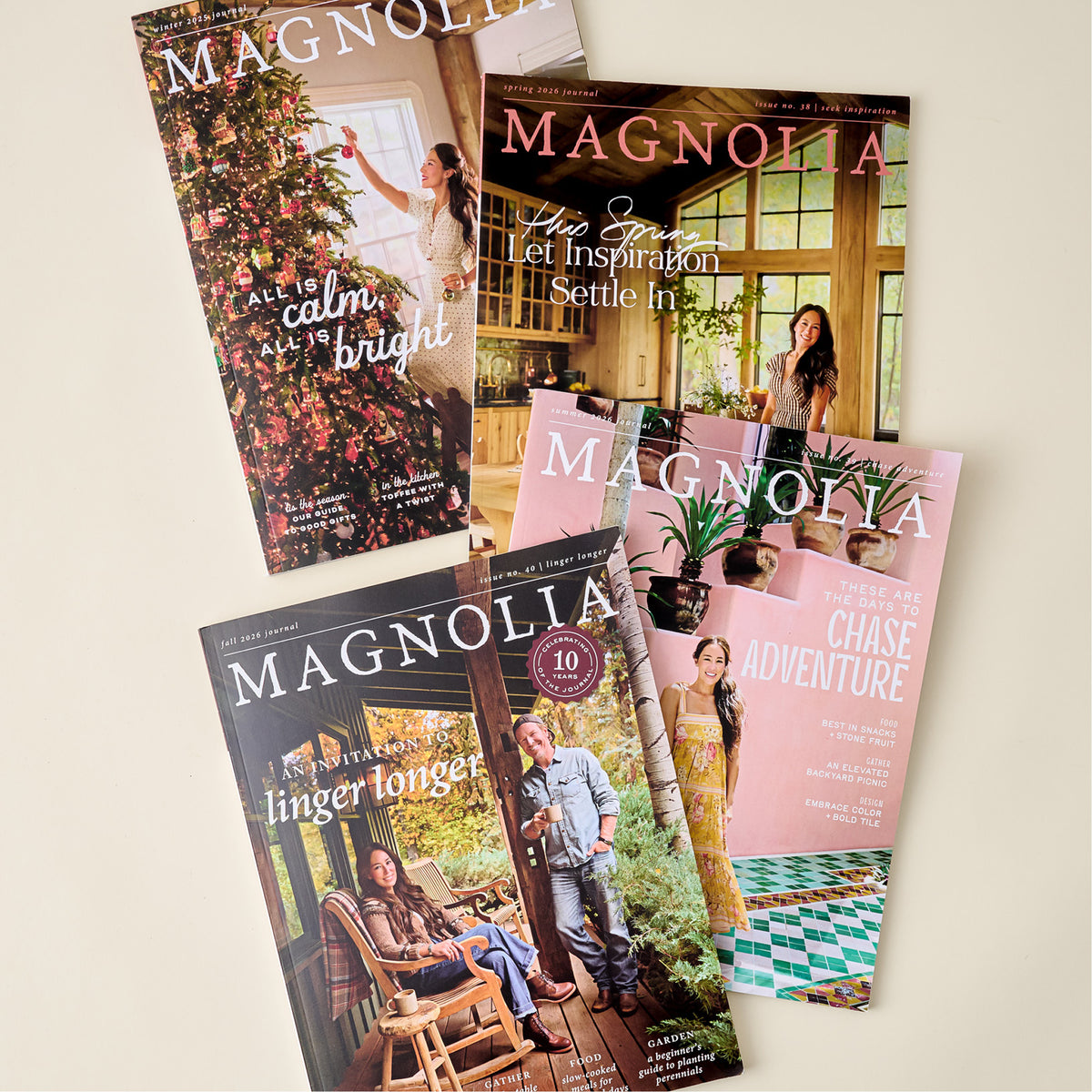 Four overlapping Magnolia lifestyle magazine covers arranged on a light beige background. The covers feature different interior and outdoor scenes with people, including floral, kitchen, porch, and pink-themed covers.