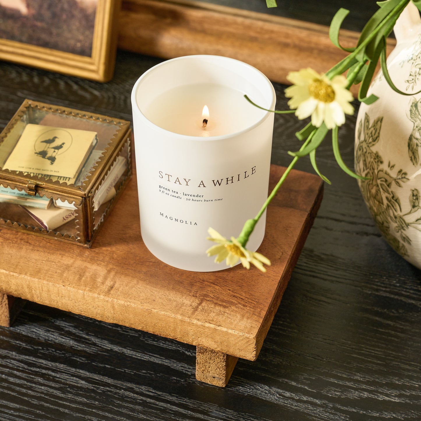 candle and keepsake box sitting on repurposed wooden riser