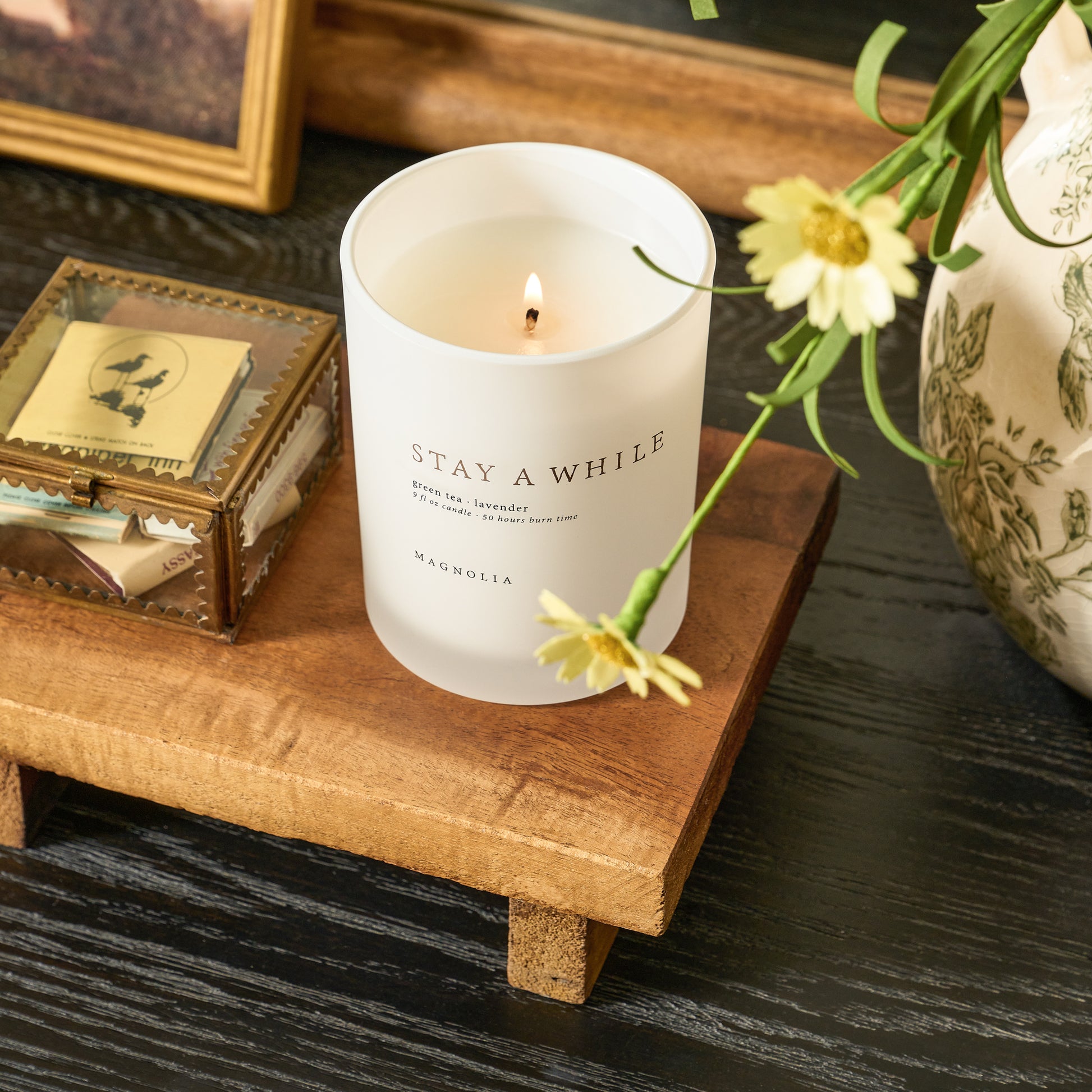 candle and keepsake box sitting on repurposed wooden riser