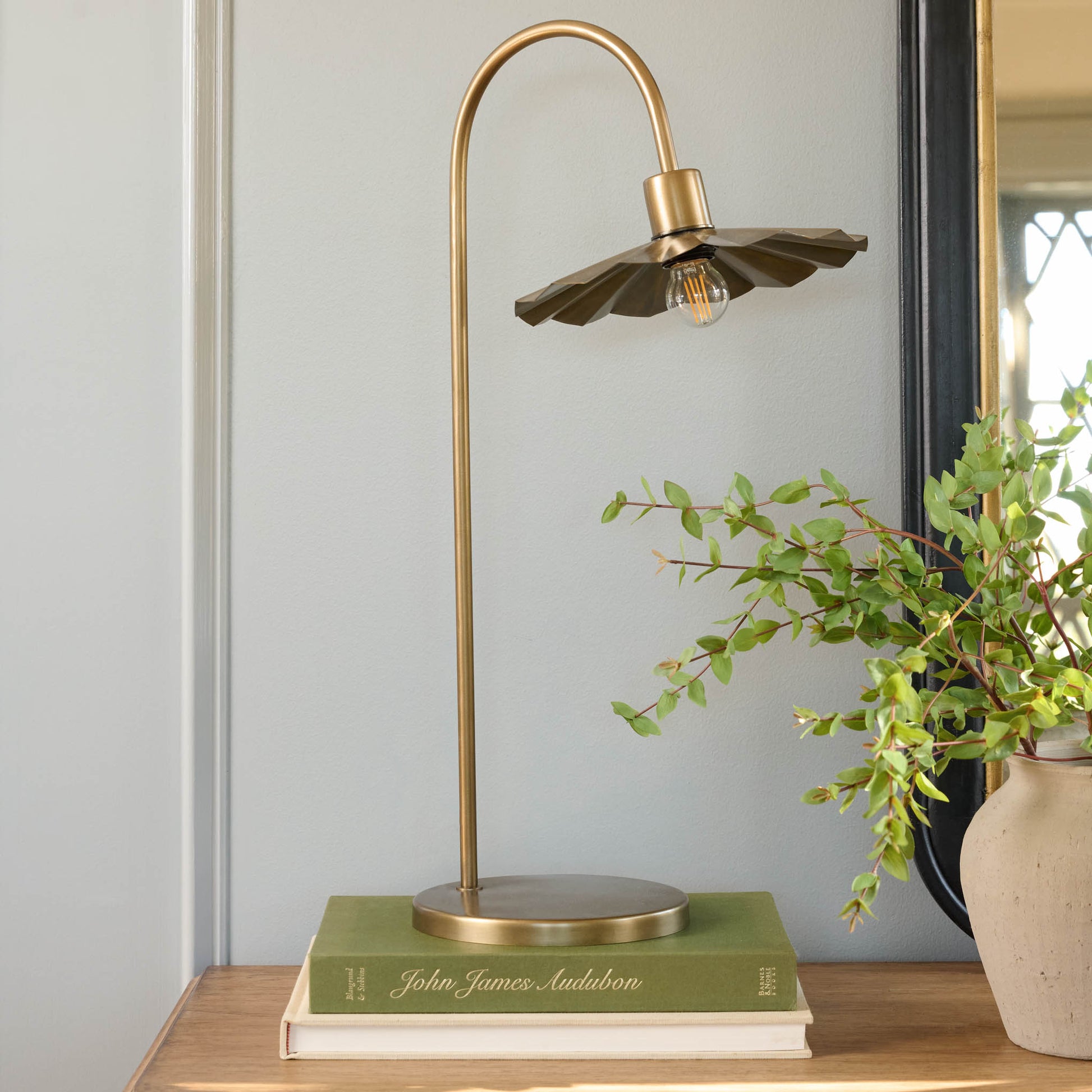 Lulu Brass Petal Lamp on coffee table books