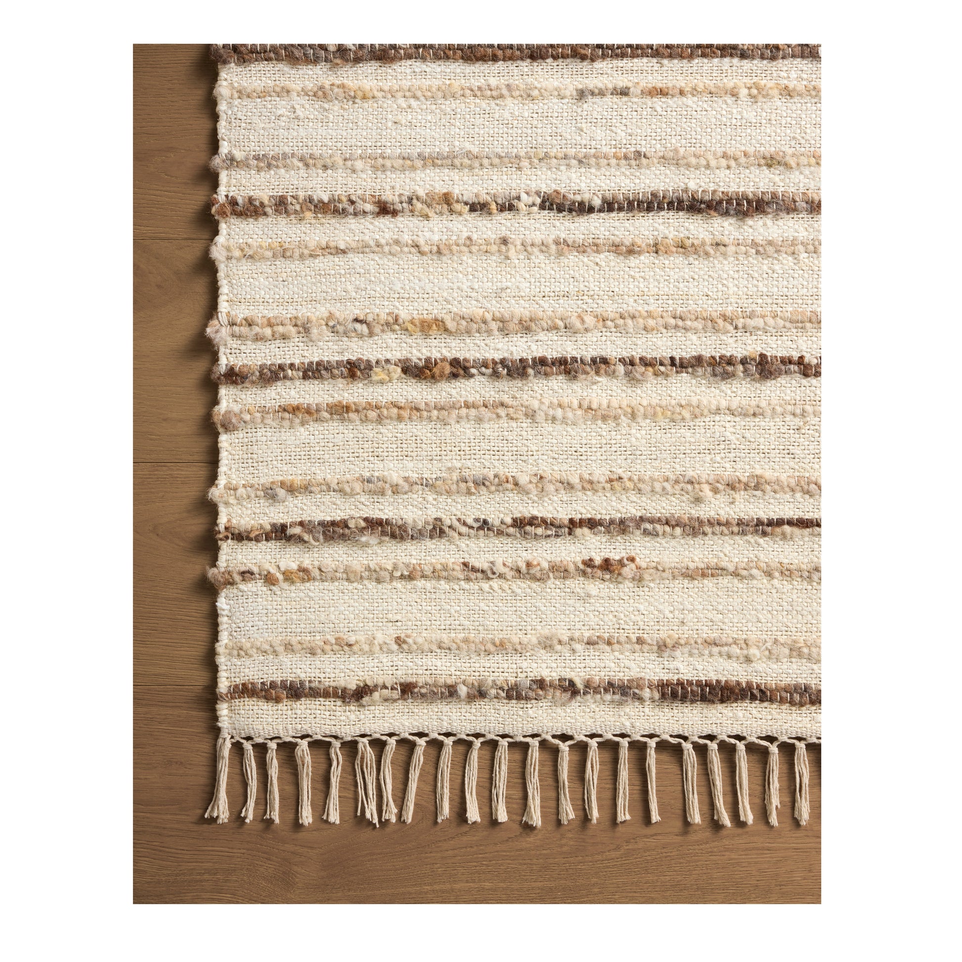 Nico Ivory Natural Rug close up of corner on wood floor