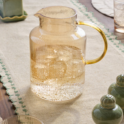 Peach Ribbed Glass Pitcher shown on table filled with water