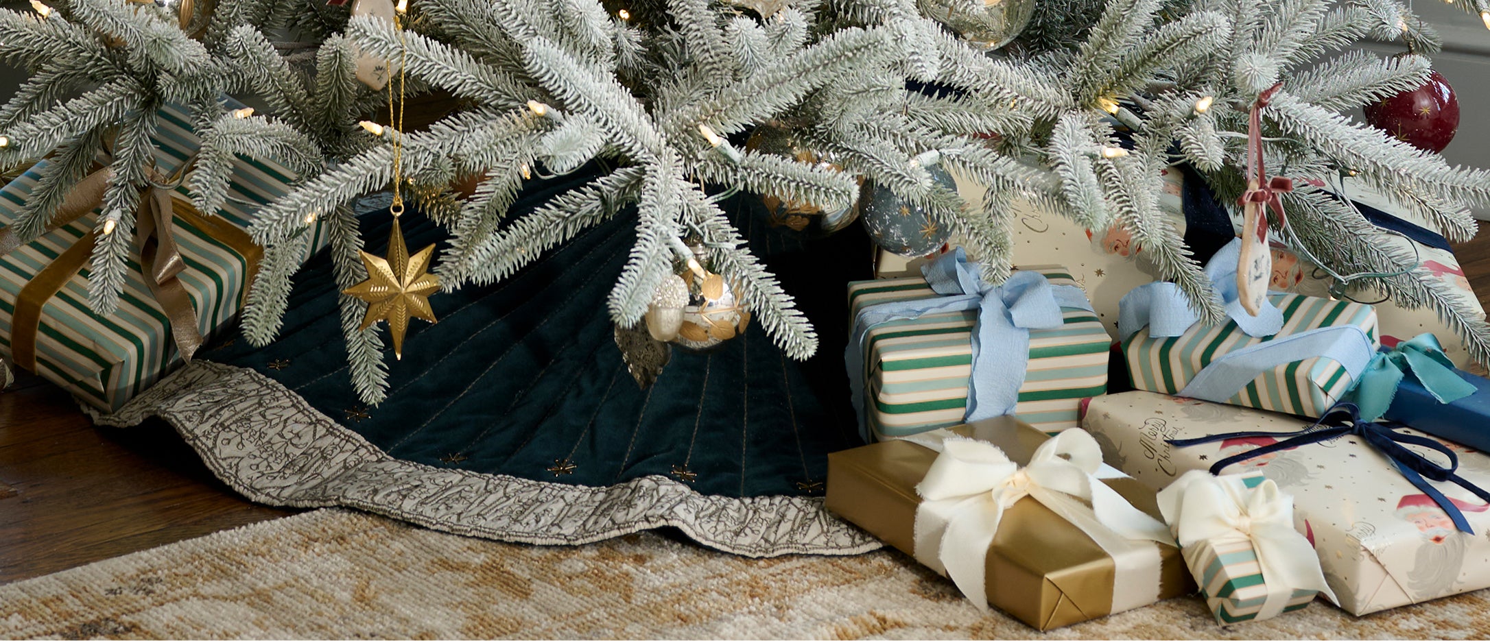 Decorated Christmas tree with presents underneath on a carpeted floor