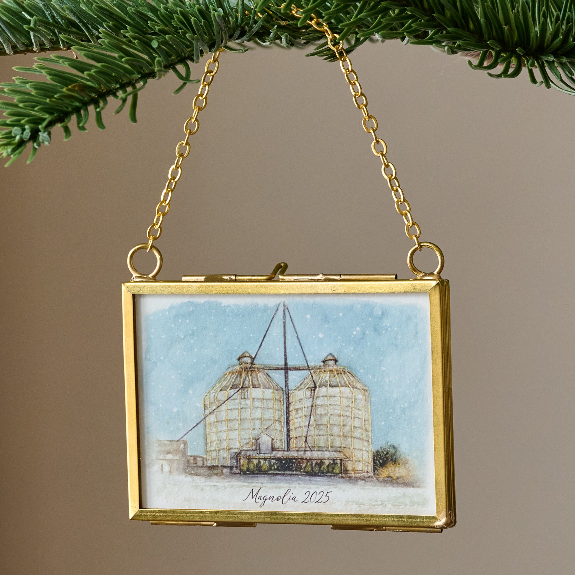 Magnolia 2025 Limited Edition Mini Framed Ornament by Tabitha Paige shown hung from branch