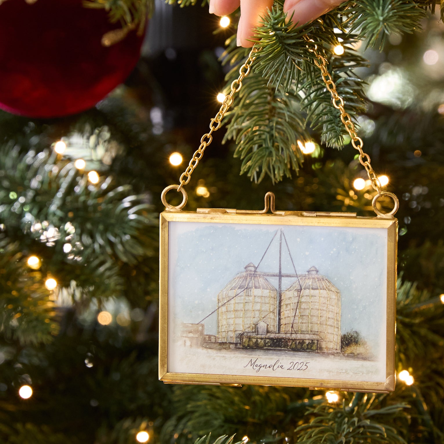 Decorative ornament with a ship illustration on a Christmas tree
