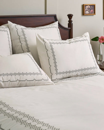 Daphne Cross-Stitch Duvet Cover shown on bed