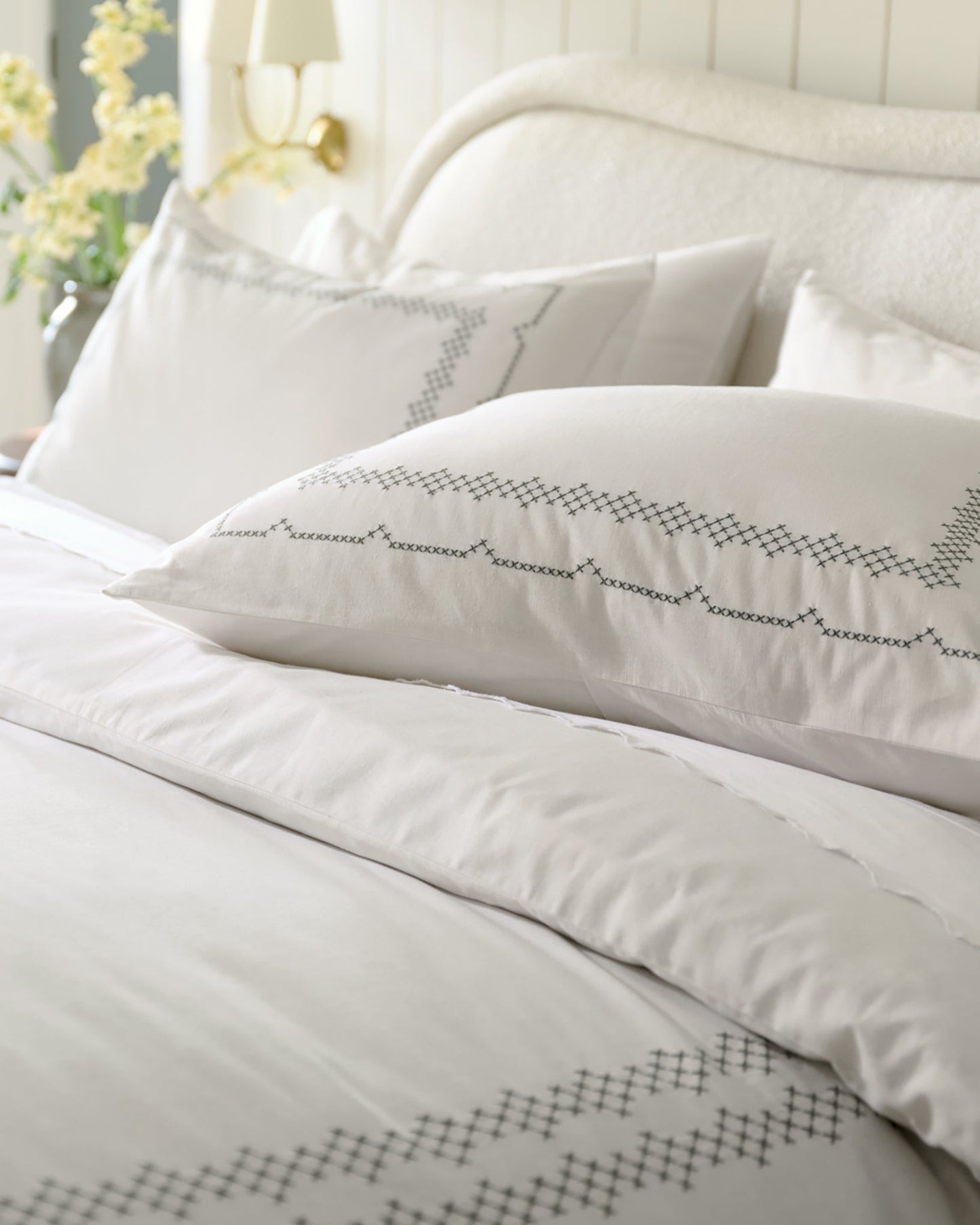 Daphne Cross-Stitch Duvet Cover shown on bed