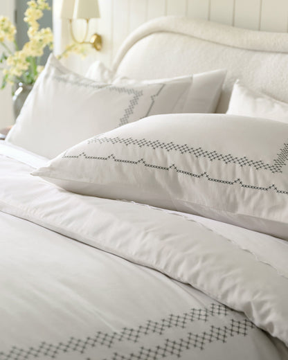 Daphne Cross-Stitch Duvet Cover shown on bed