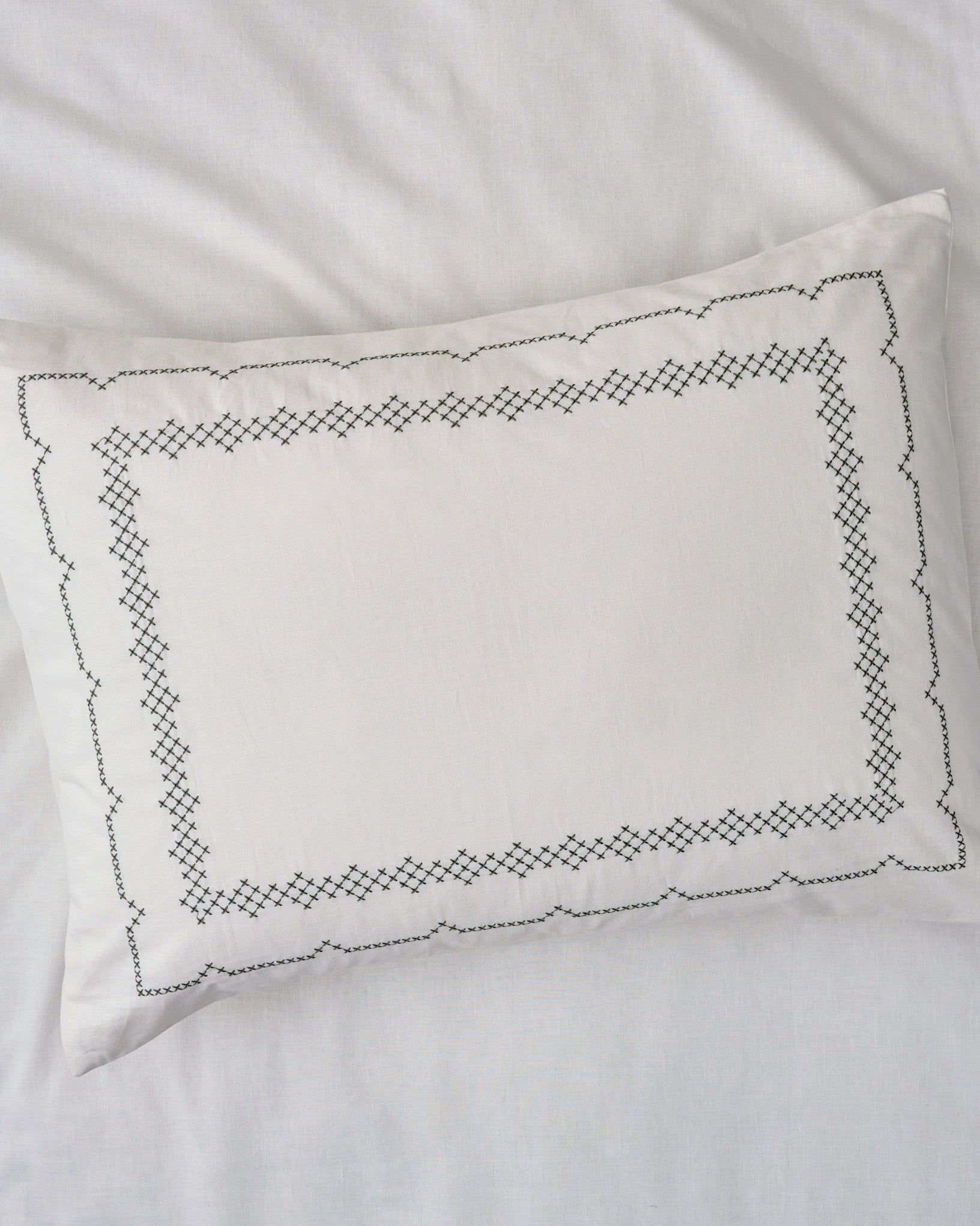 Daphne Cross-Stitch Sham queen/king shown on bed