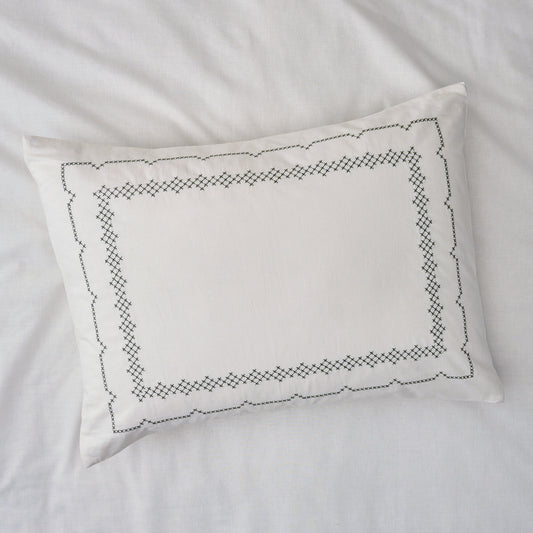 Daphne Cross-Stitch Sham queen/king shown on bed