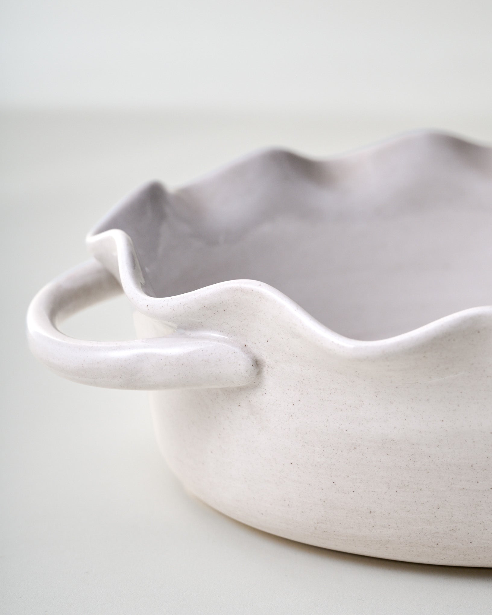 Cream Oval Scalloped Baker close up of scalloped detail and handles