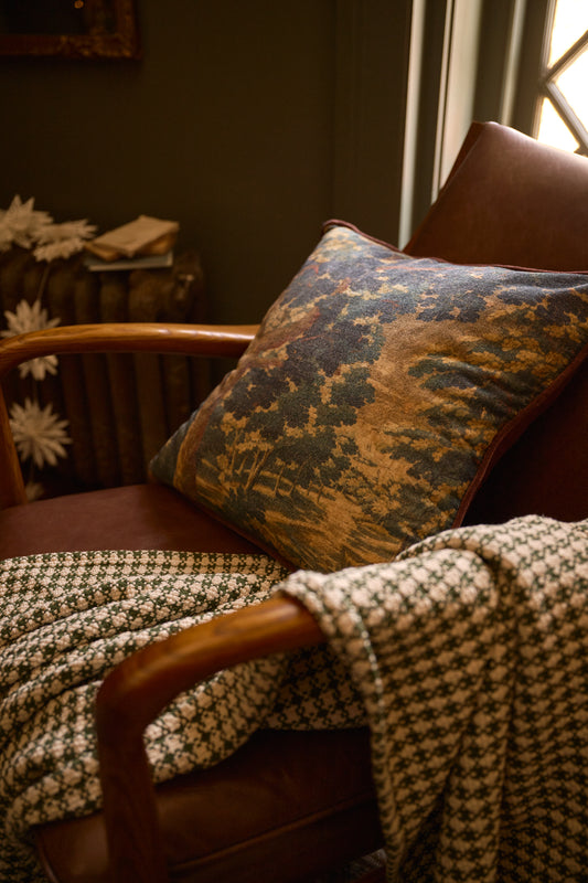 Evergrove Printed Velvet Pillow with Settle in Plaid throw on chair