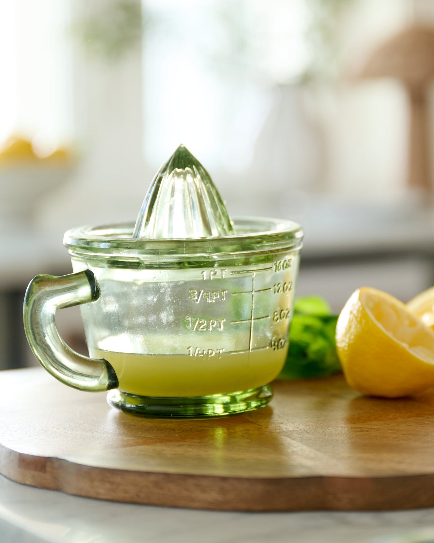 Green Glass Juicer shown with lemons