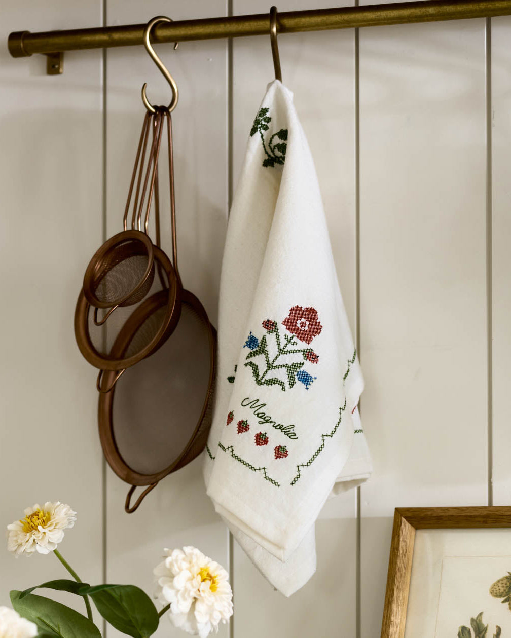 Cross Stitch Strawberry Fields Tea Towel hanging on hook in kitchen