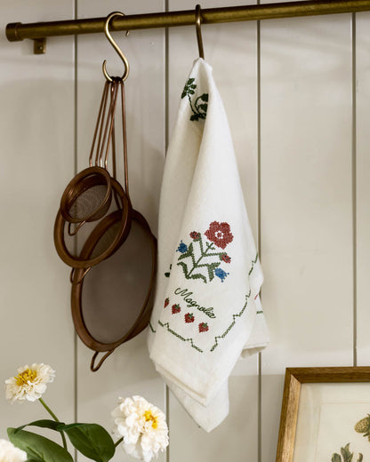 Cross Stitch Strawberry Fields Tea Towel hanging on hook in kitchen
