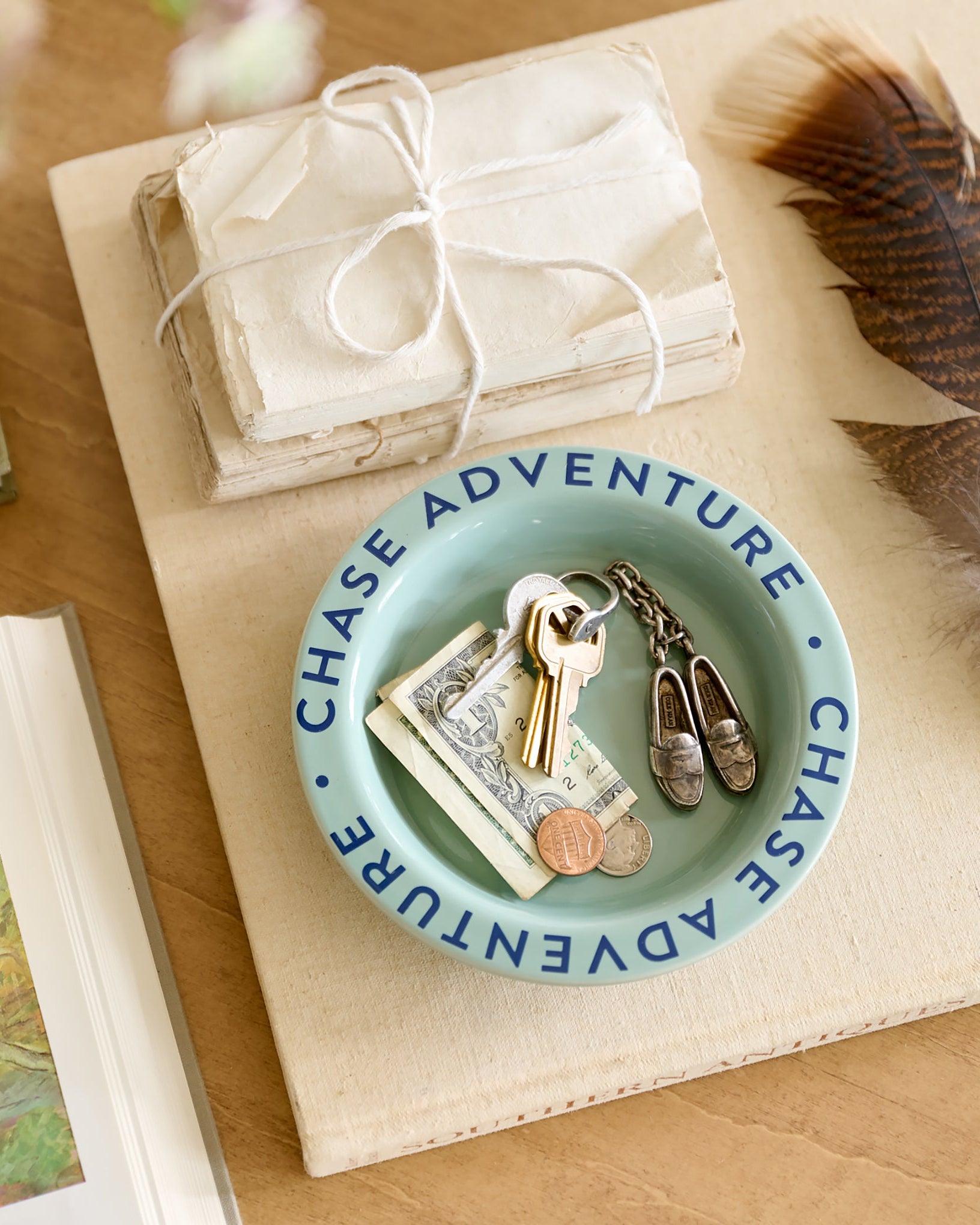 Chase Adventure Decorative Trinket Dish on top decorative book with money and keys inside dish