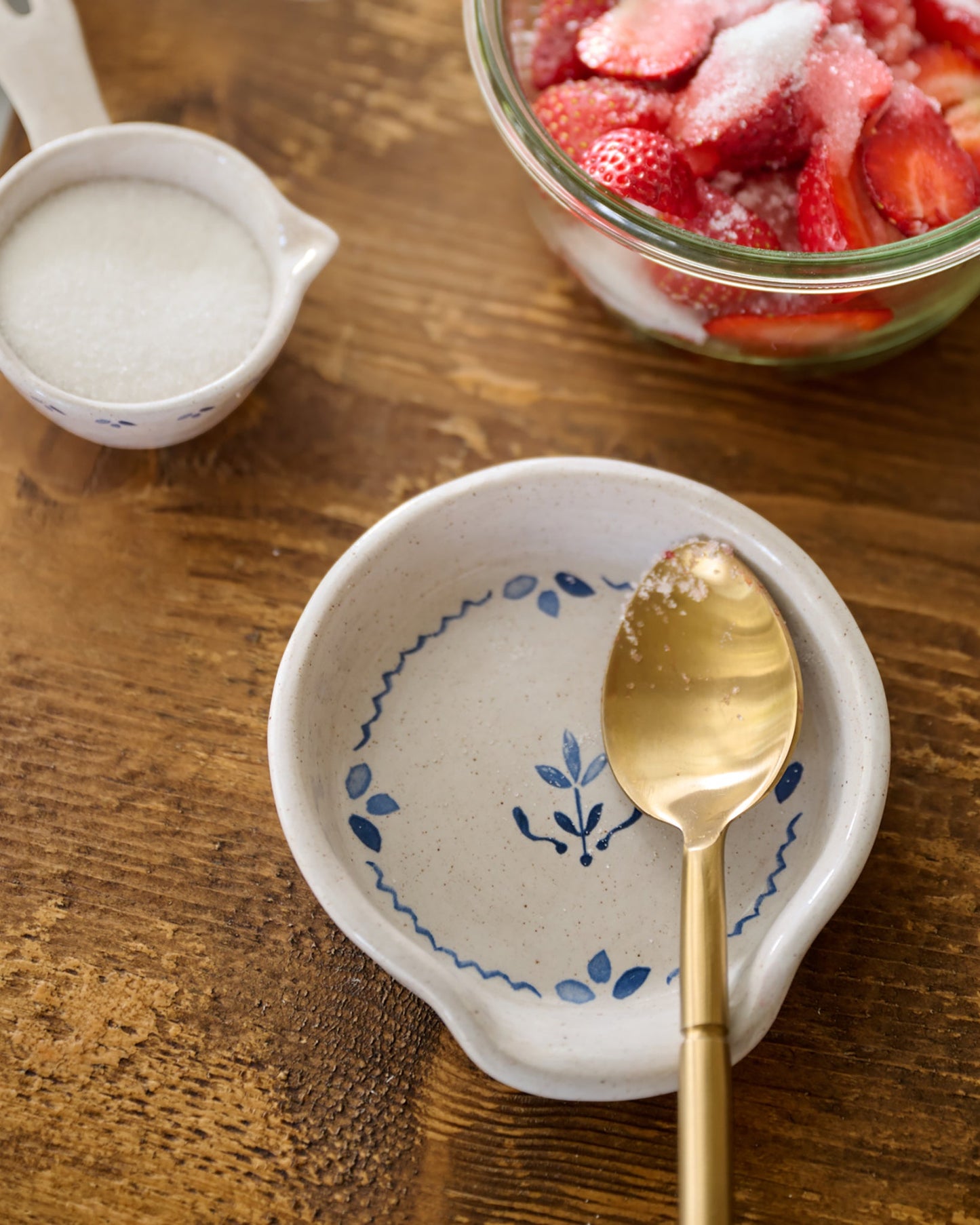 Juliet Ceramic Spoon Rest on cutting board with gold silverware