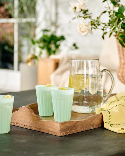 Light Green Milk Glass Tumbler on outdoor patio and wood tray