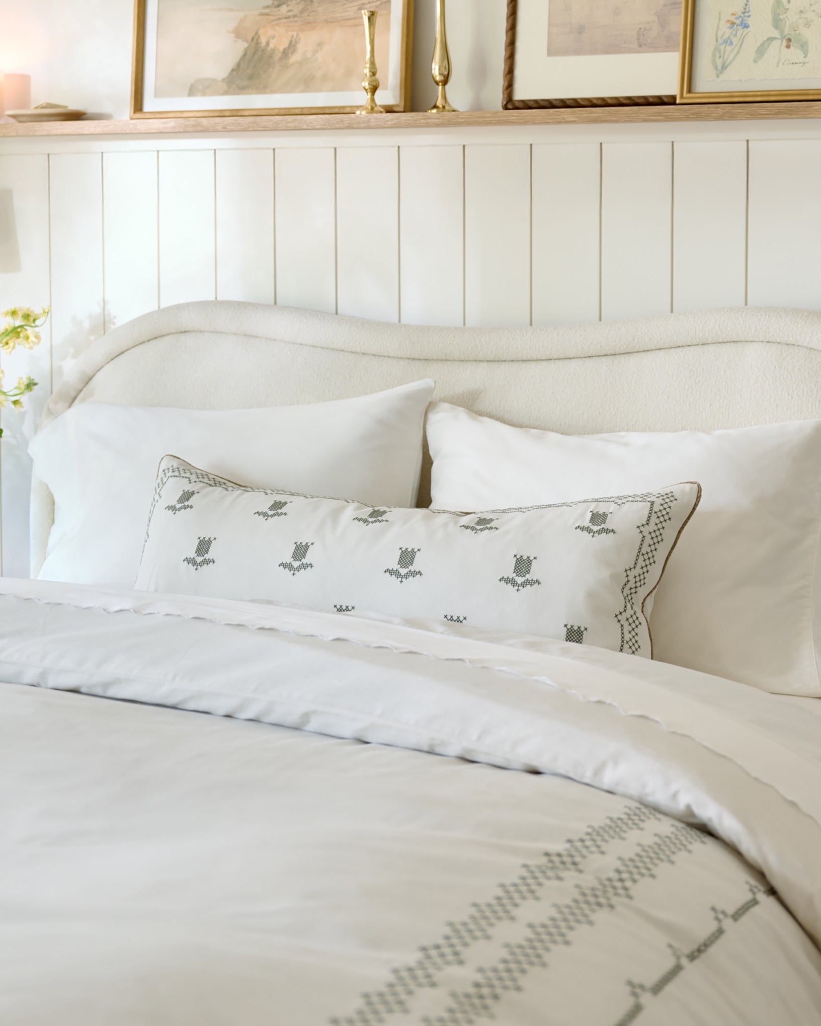Daphne Tulip Embroidered Lumbar Pillow on cross-stitch bedding in bedroom