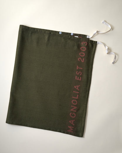Magnolia Est. Convertible Tea Towel Apron - Capers flat lay