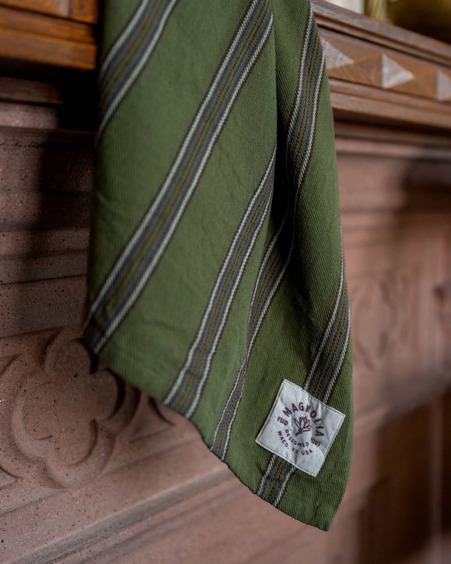 Olive Herringbone Stripe Tea Towel close up hanging off mantel