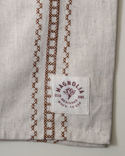 Natural Embroidered Stripe Tea Towel close up of logo