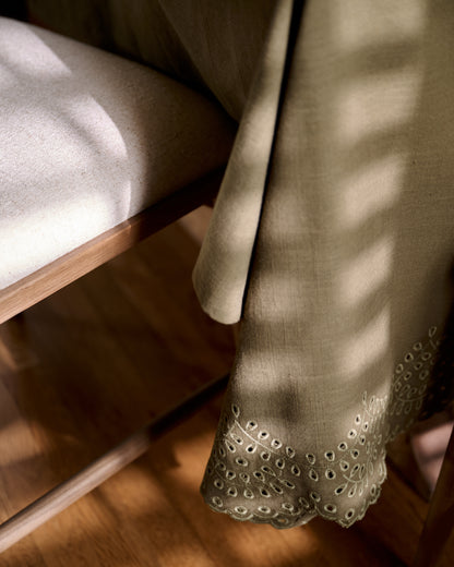 Olive Green Scalloped Eyelet Tablecloth close up next to chair