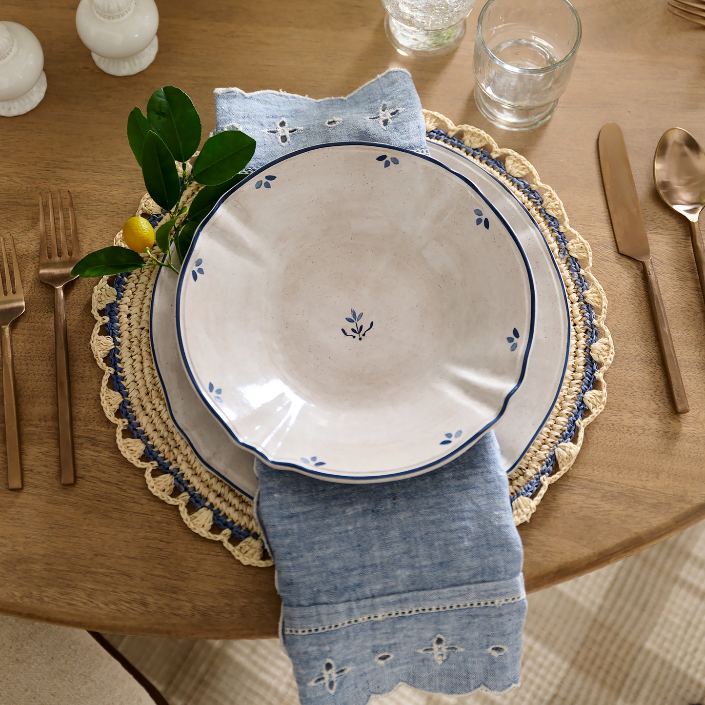 Aura Blue Edge Natural Placemat shown with place setting