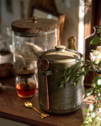 Emilie Dark Olive Canister + Scoop Small next to honey jar and canister
