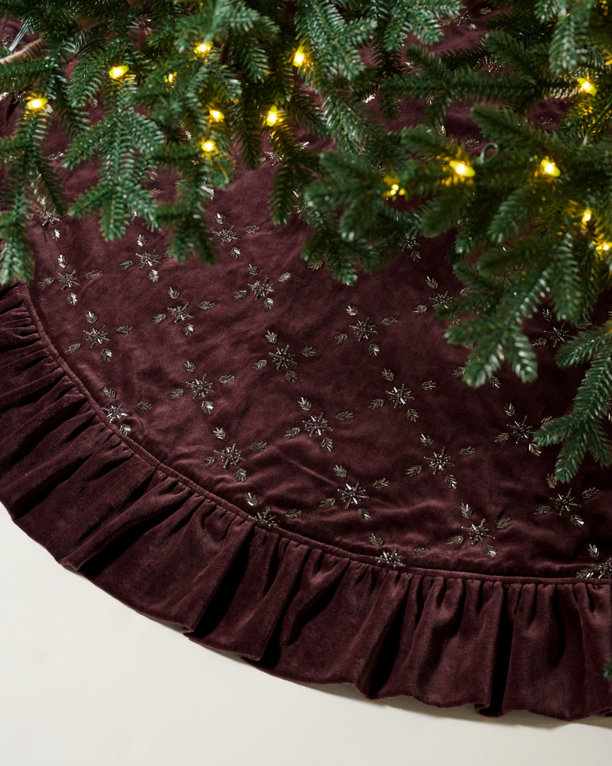 Noella Hand-Beaded Velvet Tree Skirt with a tree