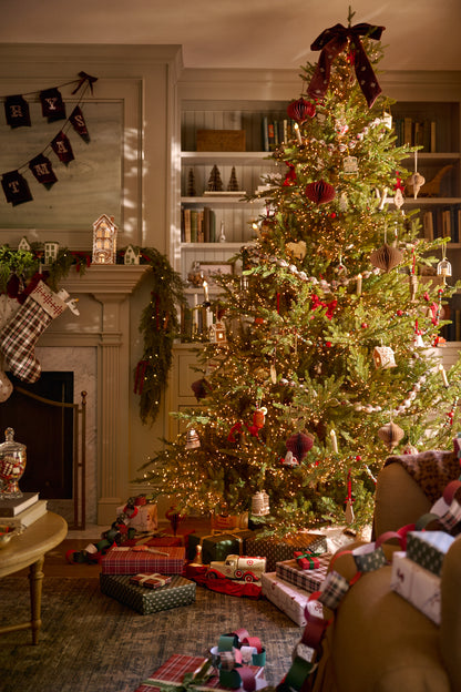 Noella Hand-Beaded Velvet Bow Tree Topper in Burgundy on a tree