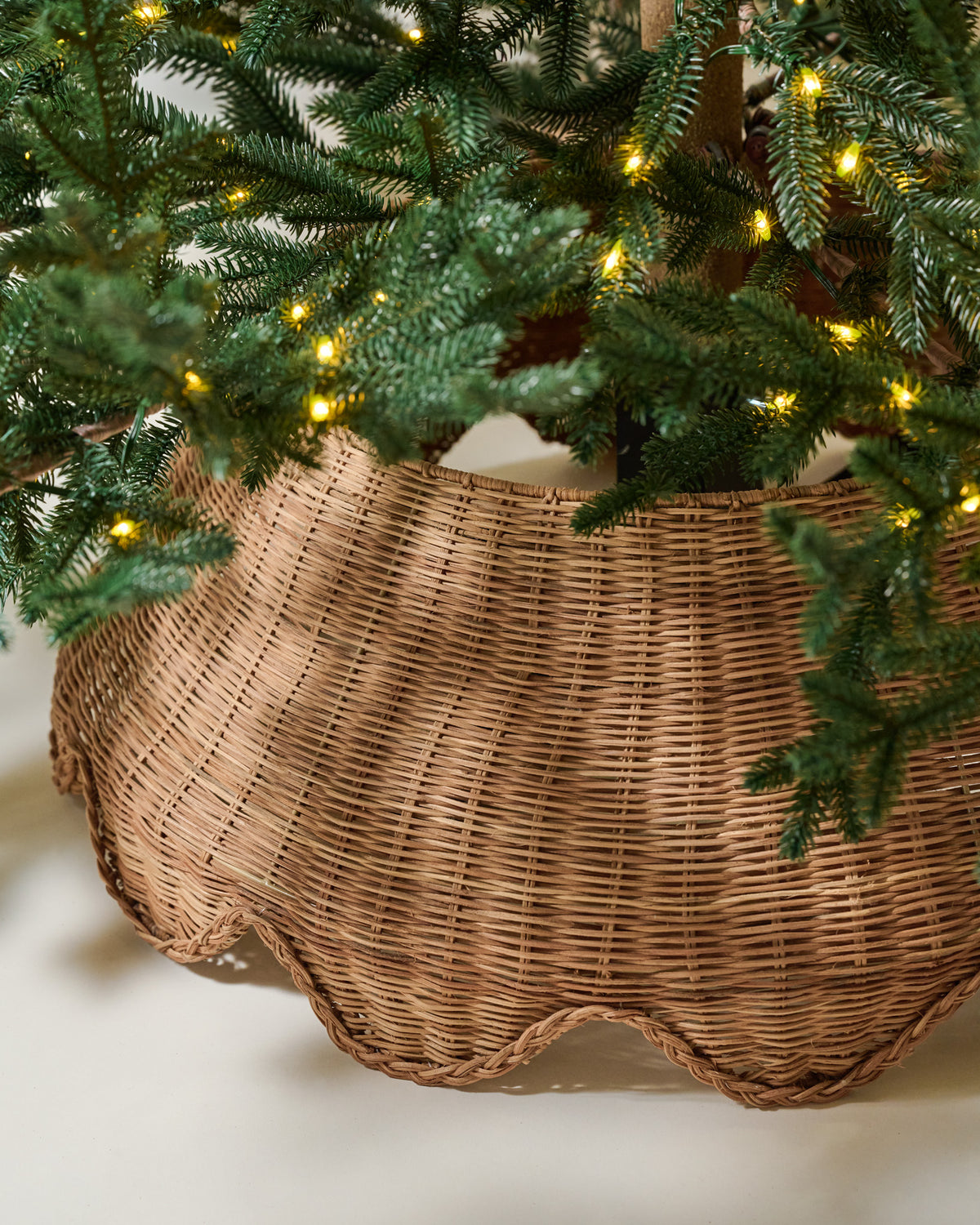 Solene Scalloped Rattan Tree Collar with a tree