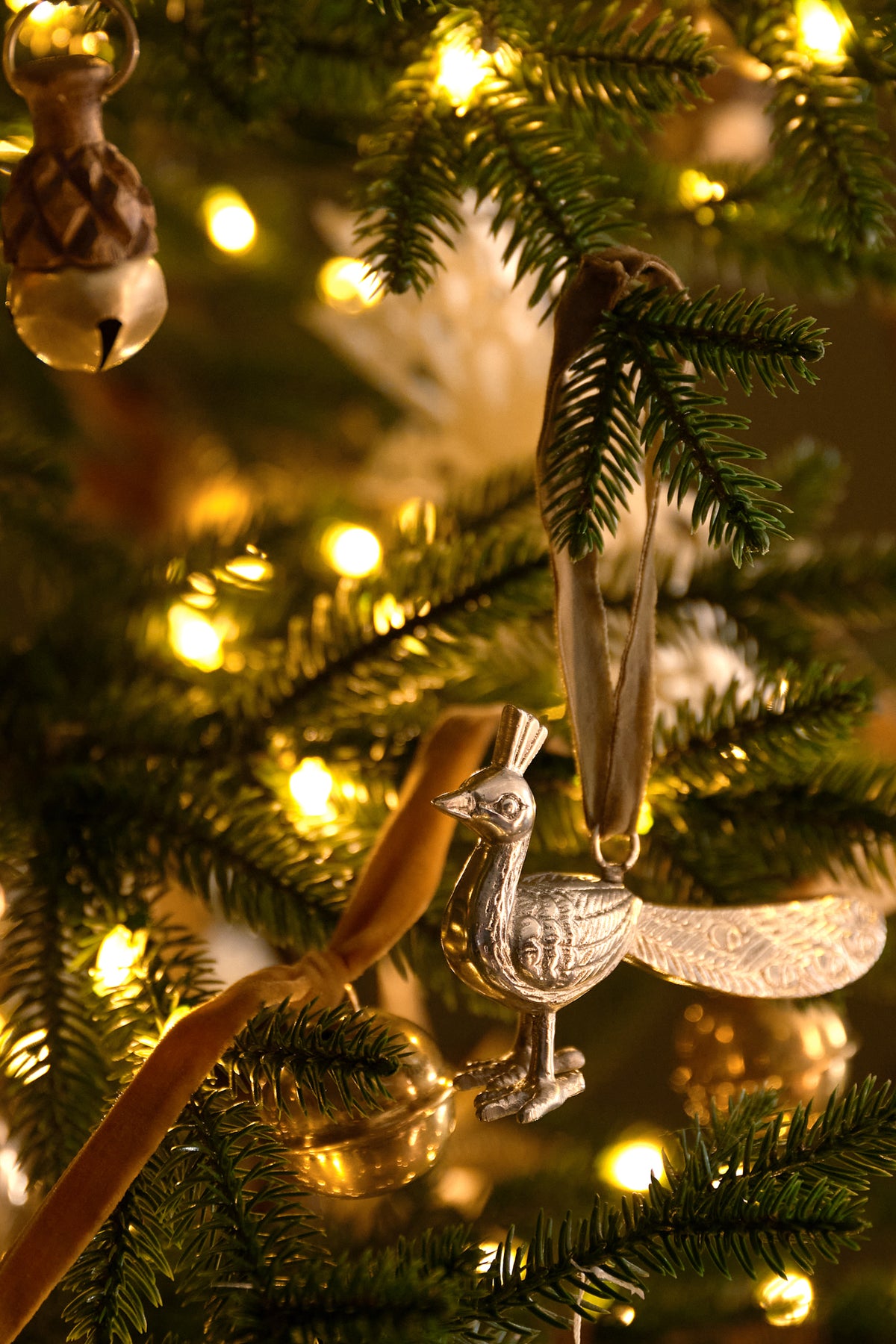 Pewter Peacock Ornament on a tree