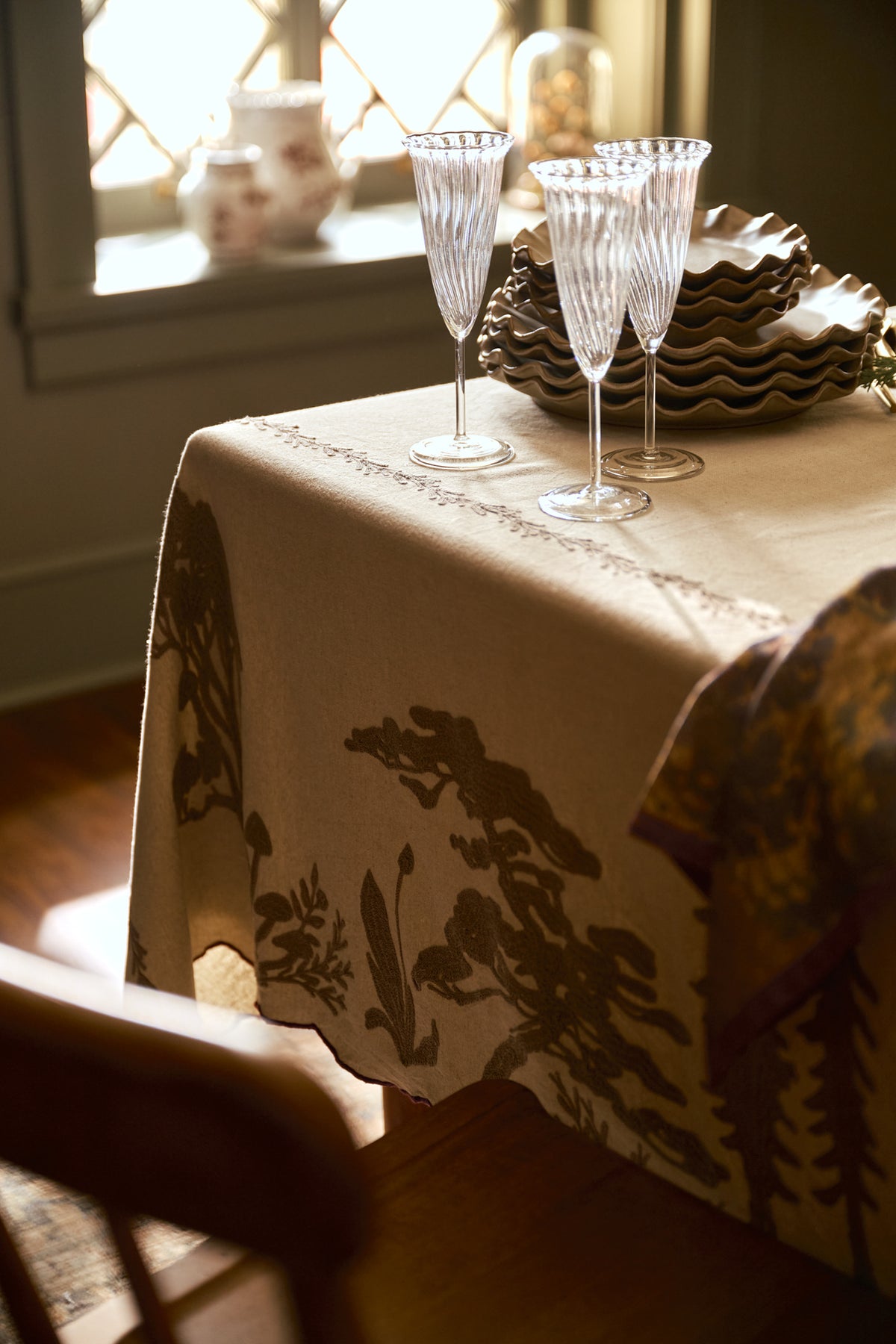 Crewel Embroidered Scalloped Tablecloth - 108"x70" on a table