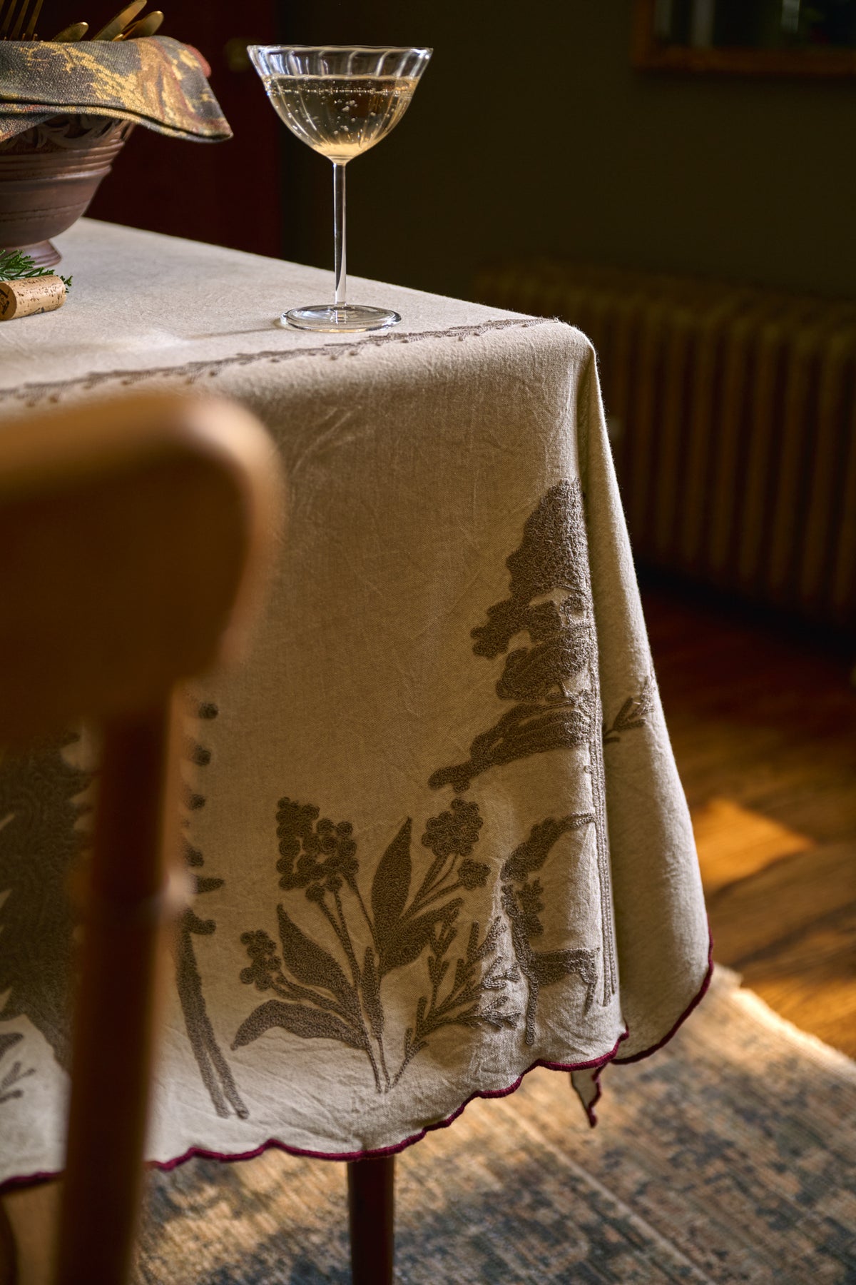 Crewel Embroidered Scalloped Tablecloth - 108"x70" on a table