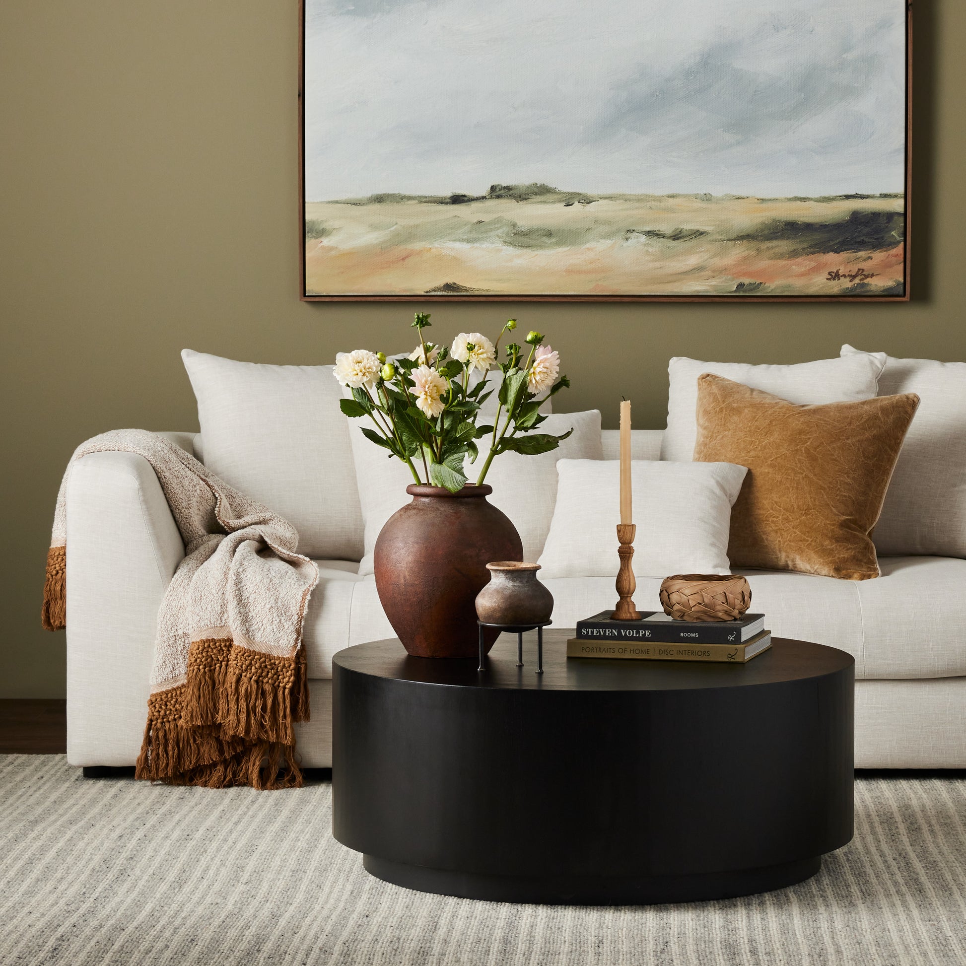 framed wall art called A Pasture by Shaina Page in a living room above a white sofa