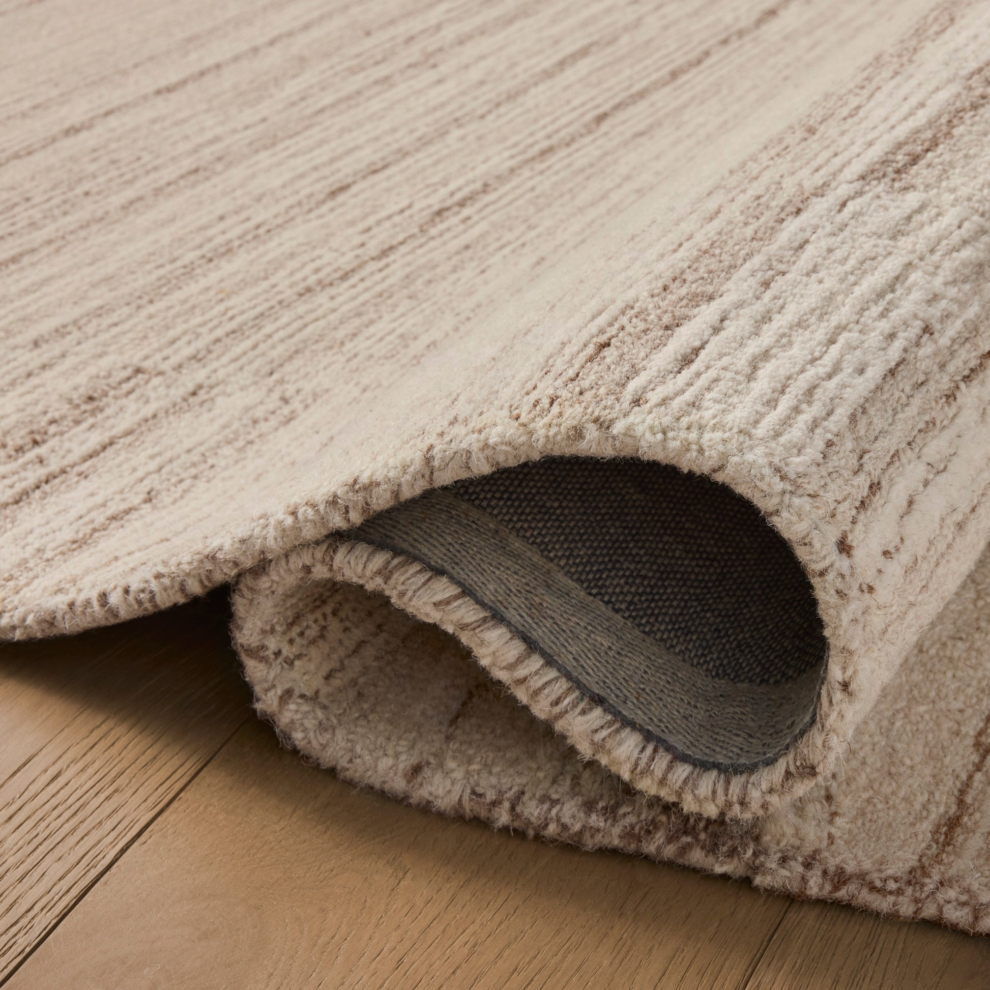 Rae Natural Oatmeal Rug close up of rolled rug
