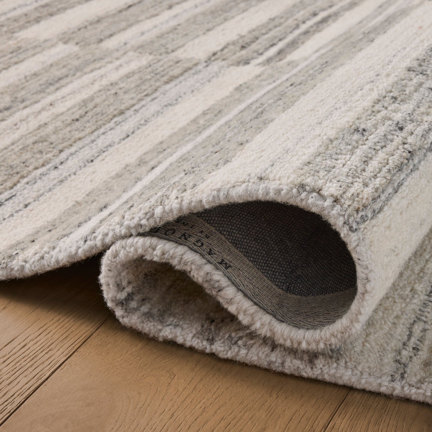 Rae Stone Ivory Rug close up of rolled rug