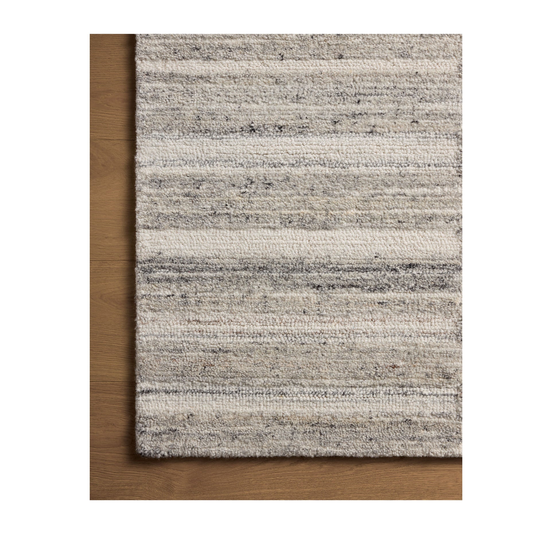 Rae Stone Ivory Rug close up of corner on wood floor