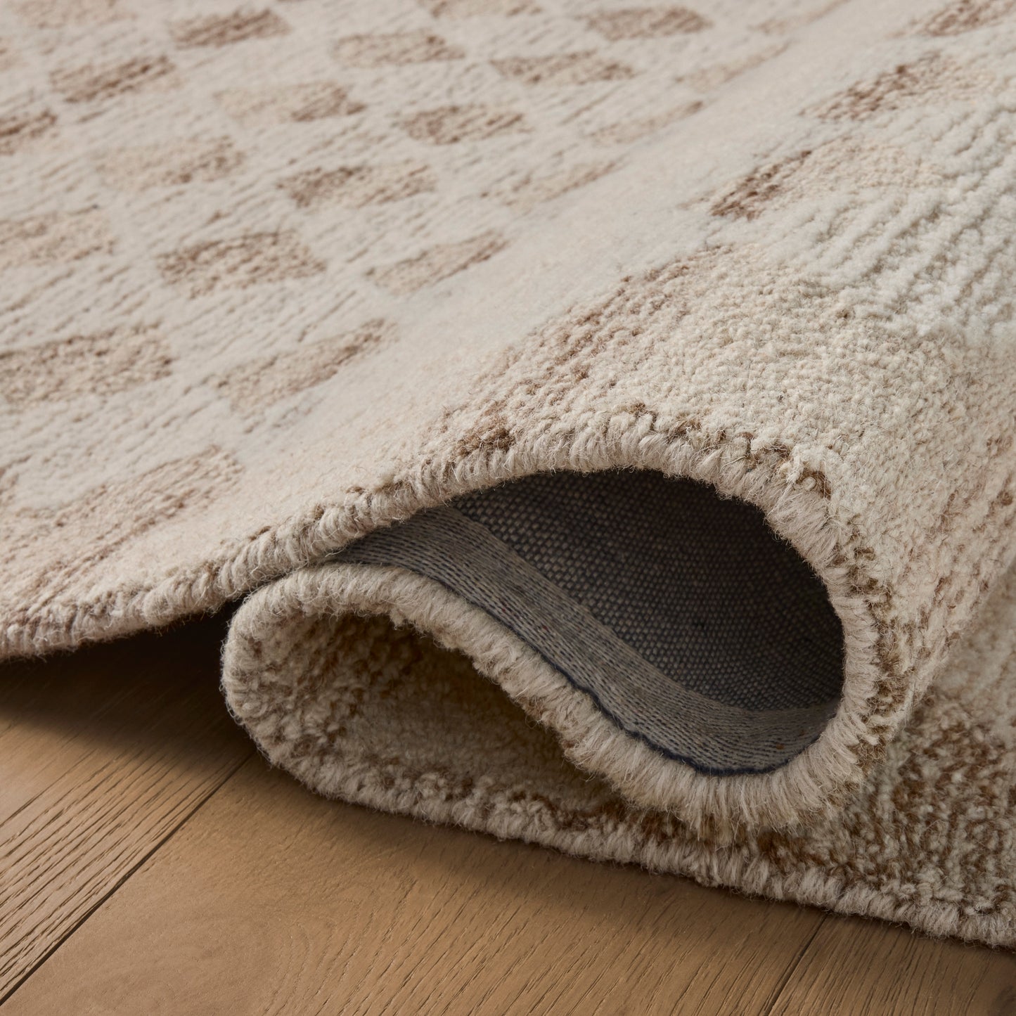 Rae Natural Ivory Rug close up of rolled rug