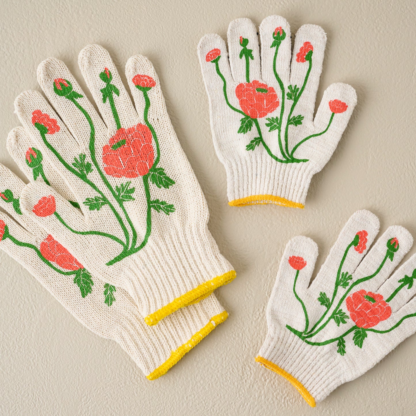 Ranunculus Adult Garden Gloves shown with kids gloves