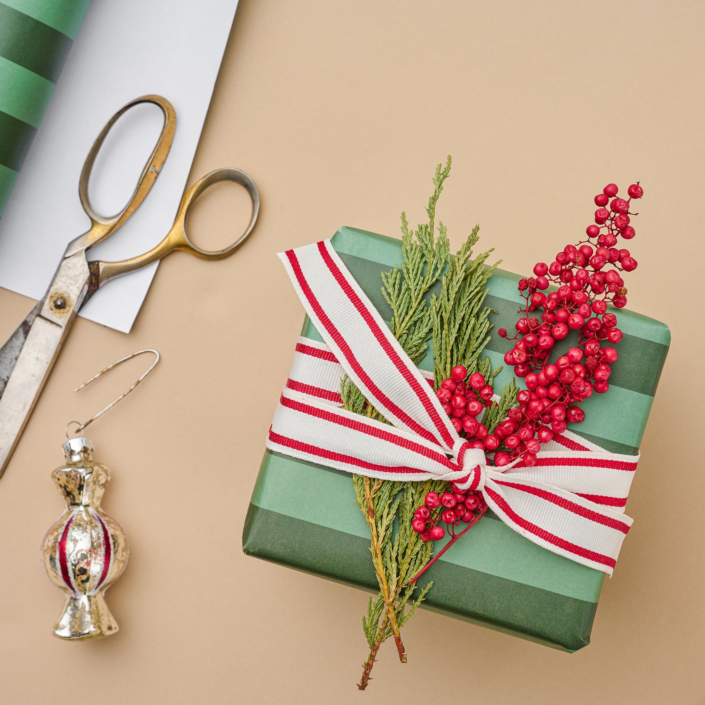 Magnolia Green Stripes Wrapping Paper Sheets wrapped on a box with embellishments