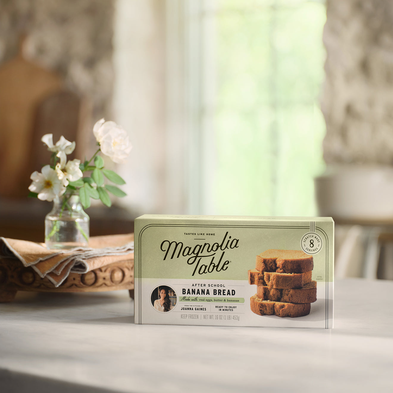 Box of Magnolia Table Frozen After School Banana Bread on a table with a blurred background.
